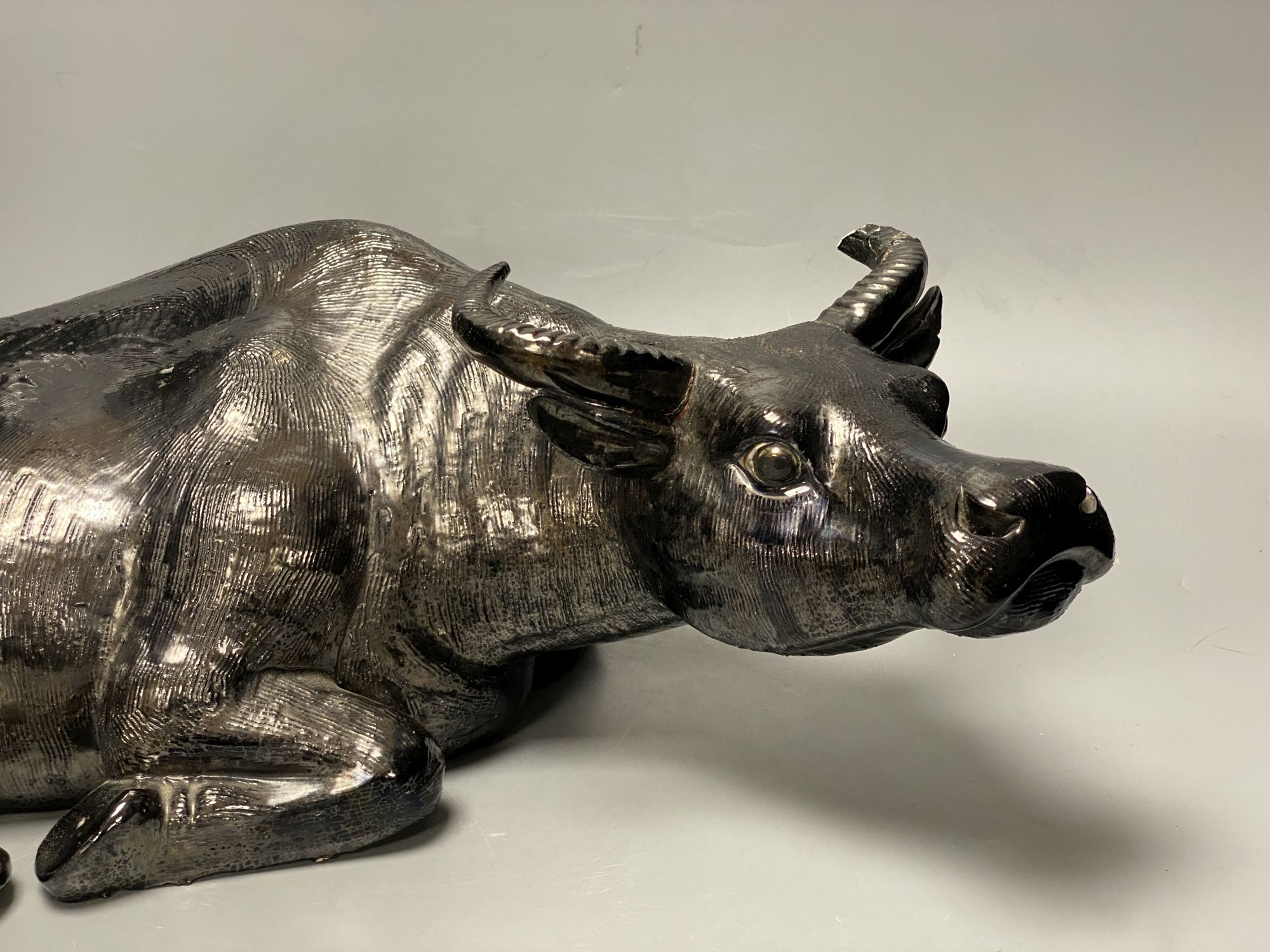 A Chinese pottery model of a recumbent buffalo, length 56cm